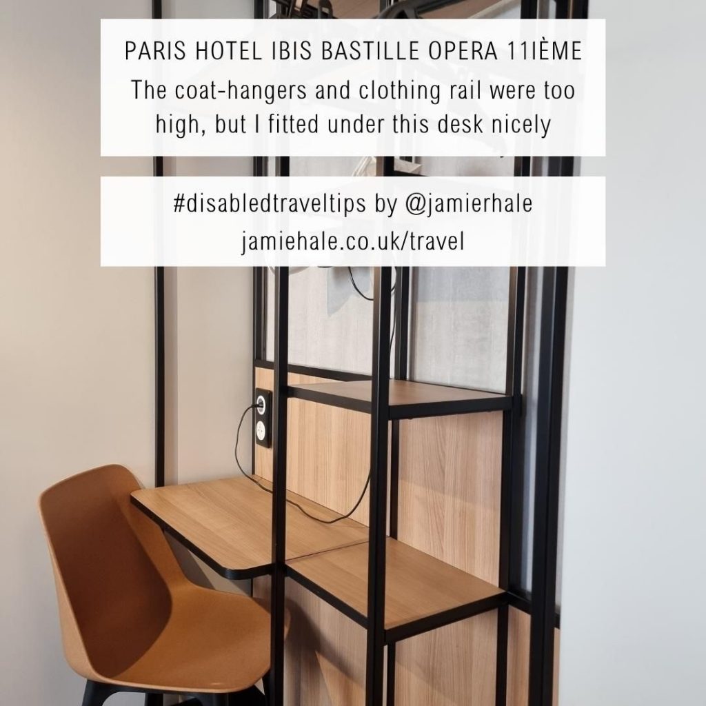 Superimposed on top of a picture of a hotel desk and clothes rails is the text "Paris (Hotel Ibis Bastille Opera 11ième, the shower chair didn't have a backrest or armrests so it was too precarious for me to use #DisabledTravelTips by @jamierhale jamiehale.co.uk/travel"