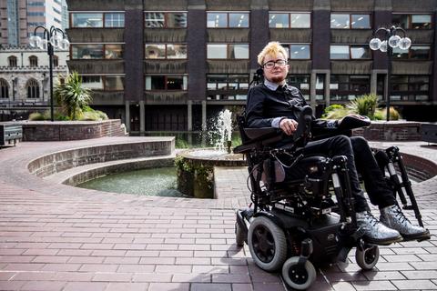 Jamie sits in front of a water fountain at the Barbican